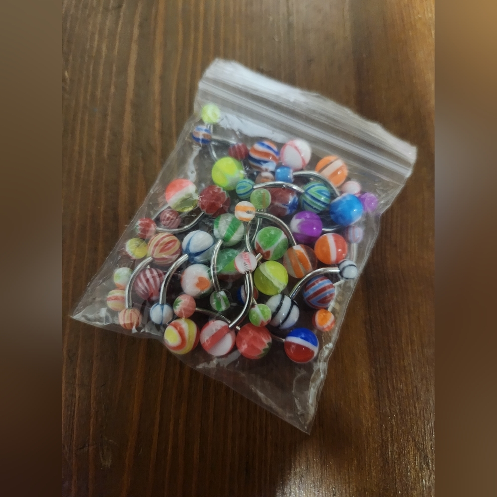 25 brand new, never used belly rings